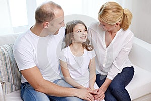 Happy parents with little daughter at home