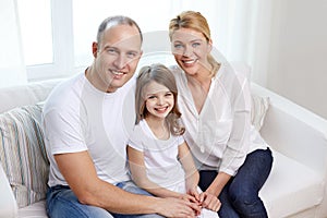 Happy parents with little daughter at home