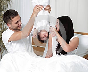 Happy parents playing with their child