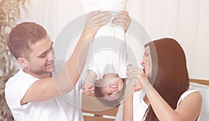 Happy parents playing with their child