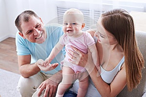 Happy parents spending time with their little girl