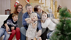 Happy parents taking selfie indoor with selfie stick