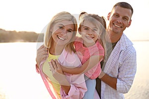 Happy parents with their child on beach. Spending time in nature