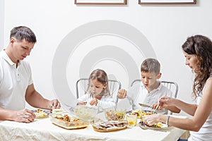 Happy Parents with Their Children Having Breakfast at Home