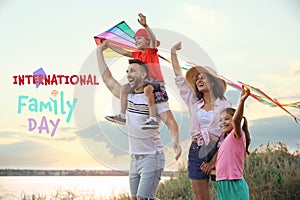 Happy parents and their children playing with kites outdoors. Happy Family Day