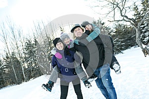 Happy parents and their kids in winterwear