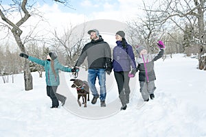 Happy parents and their kids in winterwear