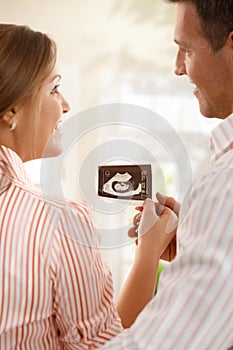 Happy parents with ultrasound baby photo