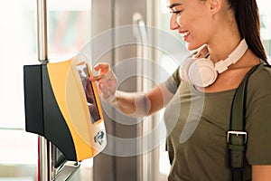 Happy Passenger Young Lady Using Ticket Machine In Train, Cropped