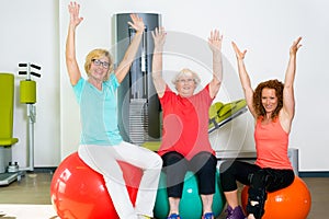 Happy patients with instructor stretching arms