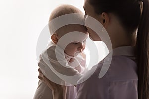 Happy peaceful mom smelling sweet pensive baby head