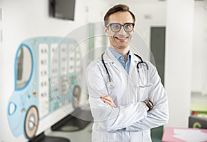 Happy pediatrician waiting for kids in clinic stock photo