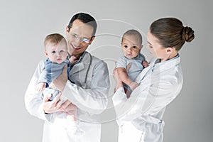 happy pediatricians holding little babies photo