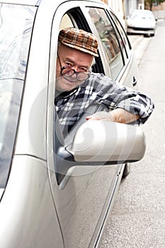 Happy pensioner driving a car