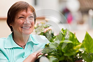 Happy pensioner woman relaxed on balcony