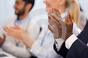 Happy people applauding at business conference