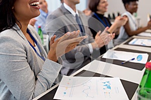 Happy people applauding at business conference