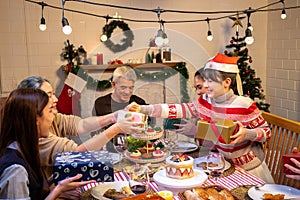 Happy people are celebrating on a table meal when christmas and new year at home