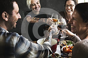 Happy people cheering with glasses of wine