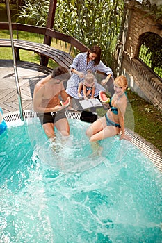 Happy people with child on swimming pool