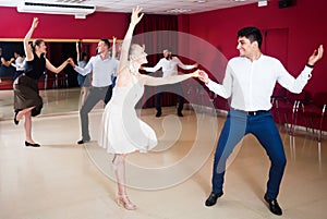 Happy people dancing lindy hop in pairs