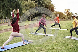 Happy people doing yoga class at city park - Focus on african woman face