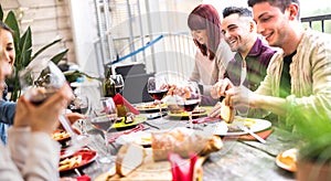 Happy people drinking wine together at rooftop party in open air villa - Young friends eating food at restaurant patio