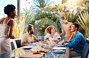 Happy people, friends and food outdoor on a table for social gathering, happiness and holiday celebration. Diversity