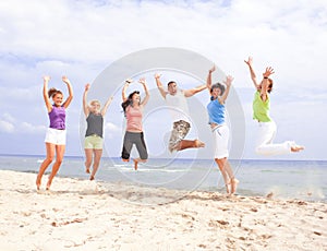 Happy people jumping on the beach