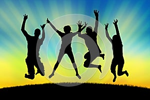 Happy people jumping in joy on a sunset background