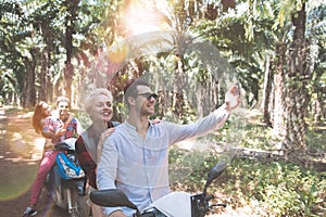 Happy People Making Selfie Portrait Riding Scooter And Enjoying Summer Vacation Road Trip Two Couple Take Self Photo On