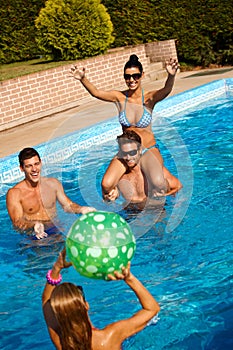 Happy people playing in swimming pool
