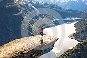Happy people relax in cliff during trip Norway. Trolltunga hiking route