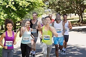 Happy people running race in park