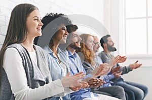 Happy People Sitting In Row Applauding To Mentor At Group Therapy