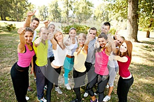 Happy people with thumbs up sign