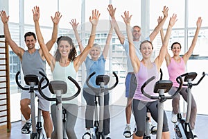 Happy people working out at spinning class