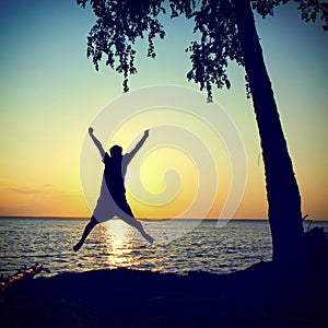Happy Person jumping on the Sunset
