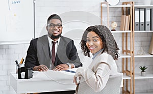 Happy personnel manager and African American vacancy candidate on job interview in office