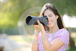 Happy photographer working with mirrorless camera