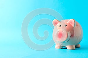 Happy piggy bank on color background, space for text