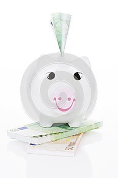 Happy piggy bank over white.