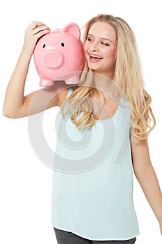 Happy, piggy bank and woman on a white background for money, savings and investment in studio. Finance mockup, cash