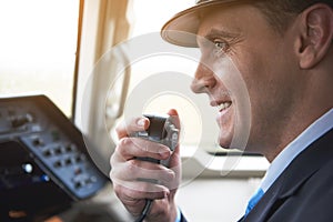 Happy pilot talking by portable radio set