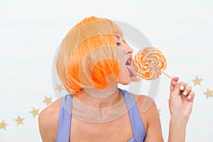 happy pinup model with lollipop. Crazy girl in playful mood. Fashion girl with orange hair having fun. Cool girl with
