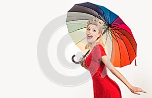 Happy pinup woman with umbrella at rainy weather. Rain rainbow autumn mood, pin up girl in red dress isolated white.