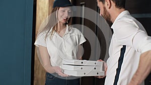 Happy Pizza Delivery woman Visits Home With Boxes To A Customer. Giving money to worker and showing thumbs up.