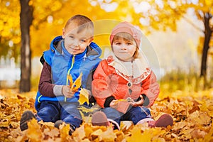Happy playful children in the autumn park