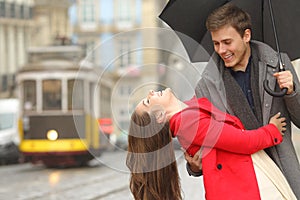 Happy playful couple joking in the street photo