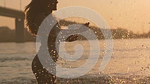 Happy playful couple splashing water and having fun and joyful evening